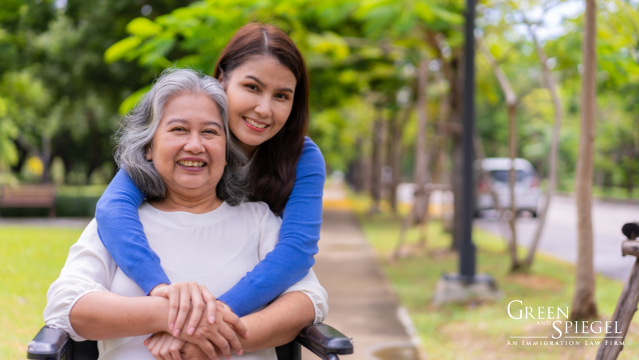 caregiver hugging woman in wheelchair - caregivers pilot programs